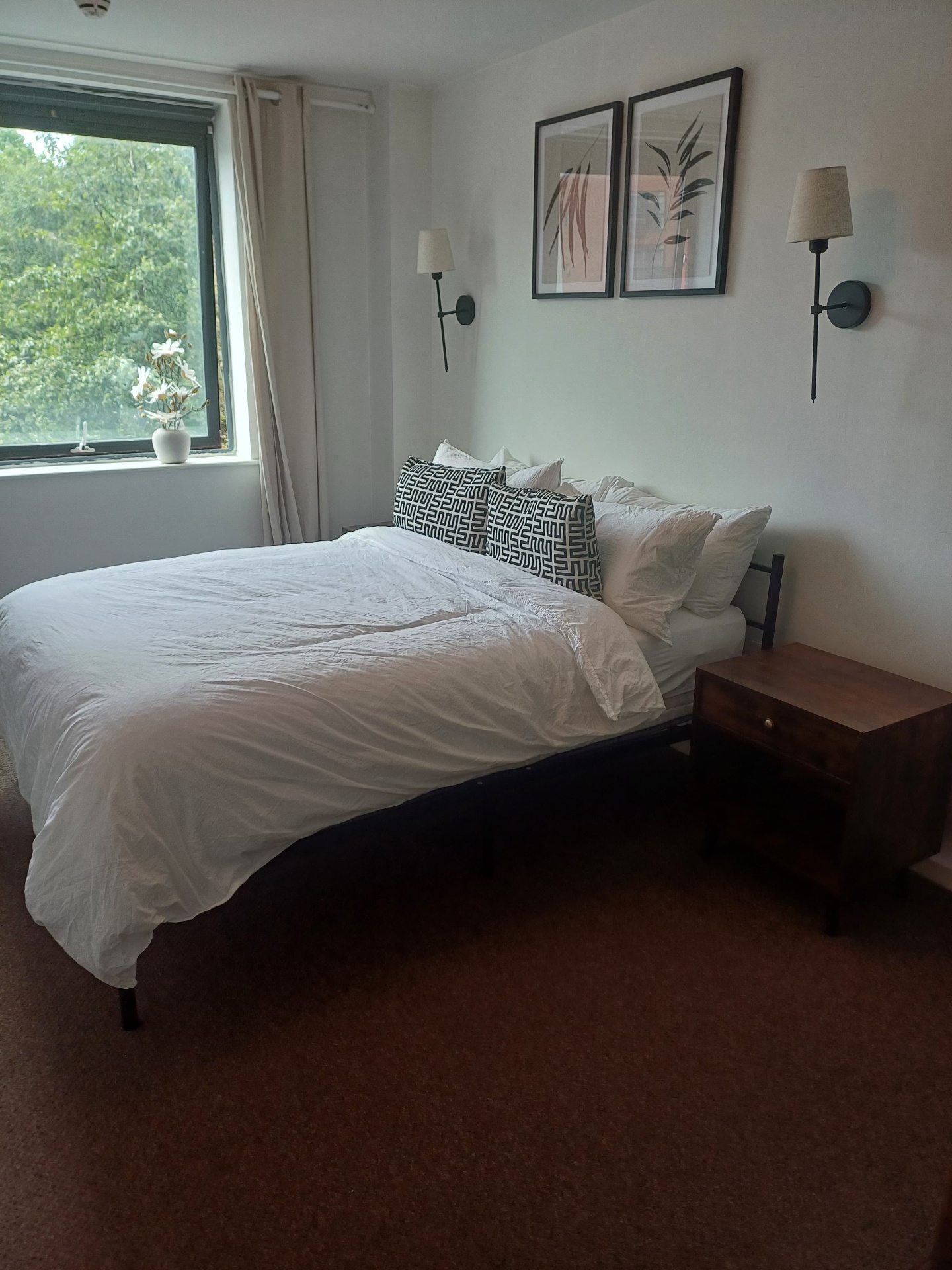 Freshly made bedroom with styled linen
